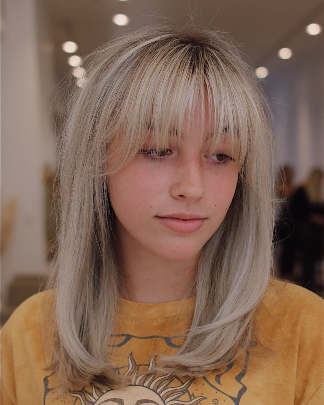 Medium Hairstyle with Light Arched Wispy Bangs